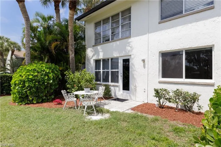 Back of property with a lawn