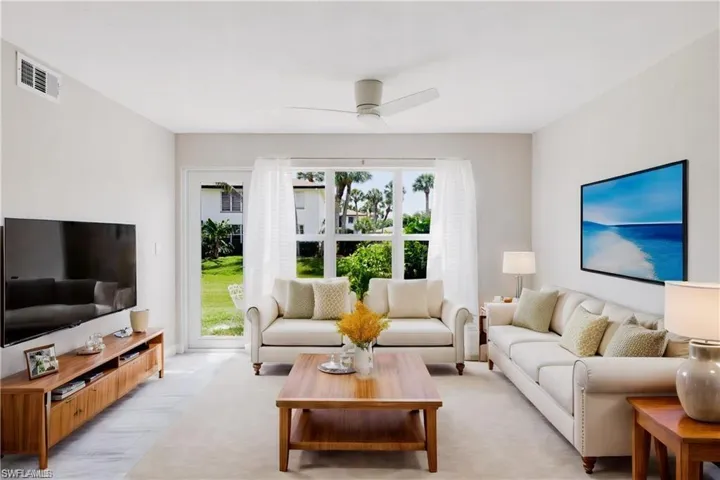 Living room featuring light hardwood / wood-style floors and ceiling fan