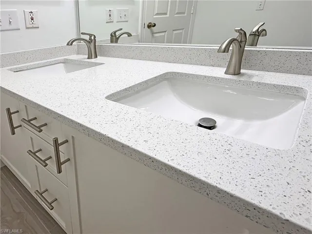 Updated quartz counter and dual sinks in the owner's bath.