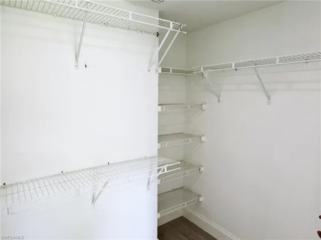 Walk-in closet with plenty of storage.