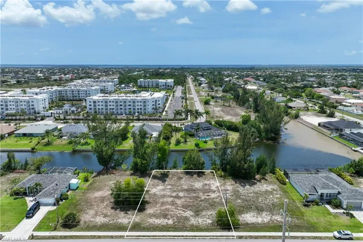Aerial view of property's location featuring a large body of water and property boundaries highlighted