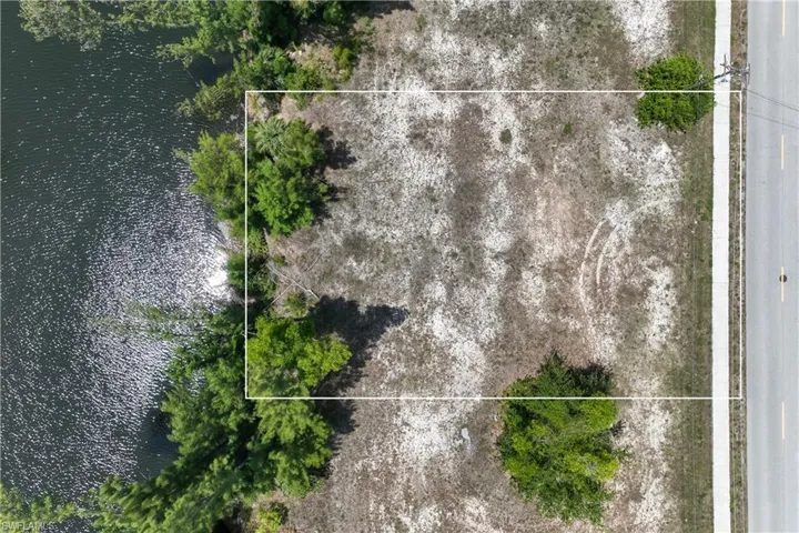 View of property location with a nearby body of water and property boundaries highlighted
