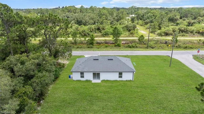 View of subject property featuring a heavily wooded area