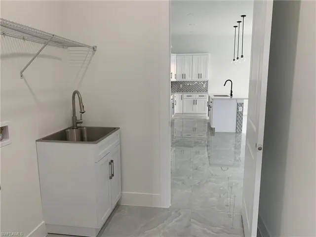 Built in sink, shelving + washer & dryer will be installed