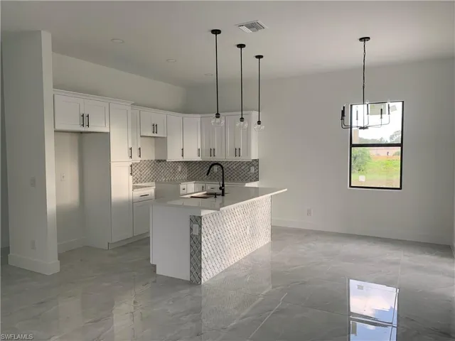 Kitchen, island bar + dining room