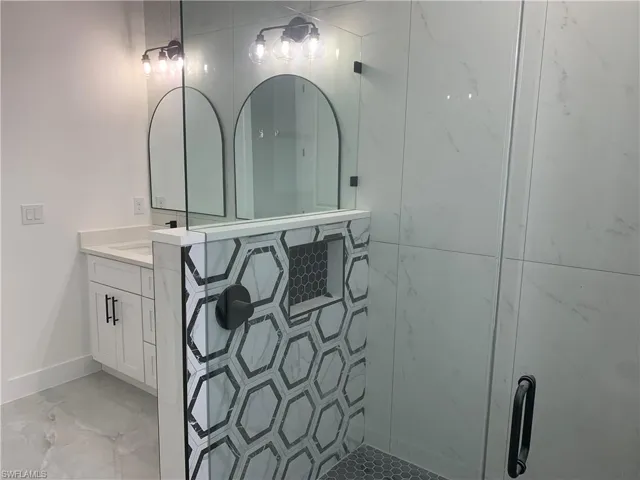 Custom glass + tile shower with recessed niche