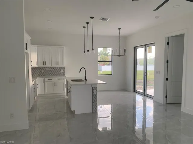Kitchen, dining room, porch sliding door + master bedroom door view