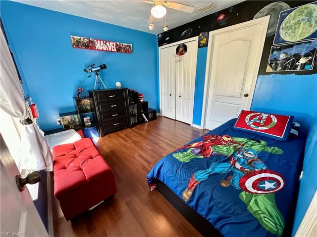 Bedroom featuring ceiling fan and dark hardwood / wood-style floors