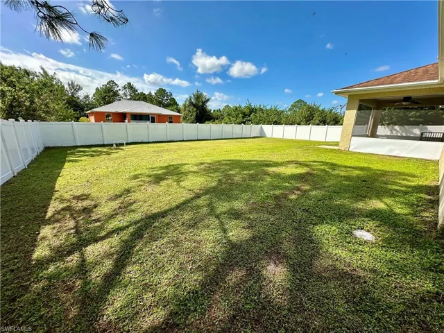 View of yard featuring ceiling fan and a patio