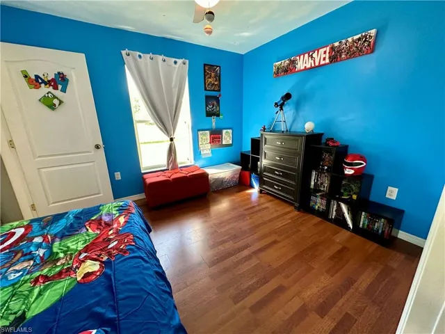 Bedroom featuring wood-type flooring and ceiling fan