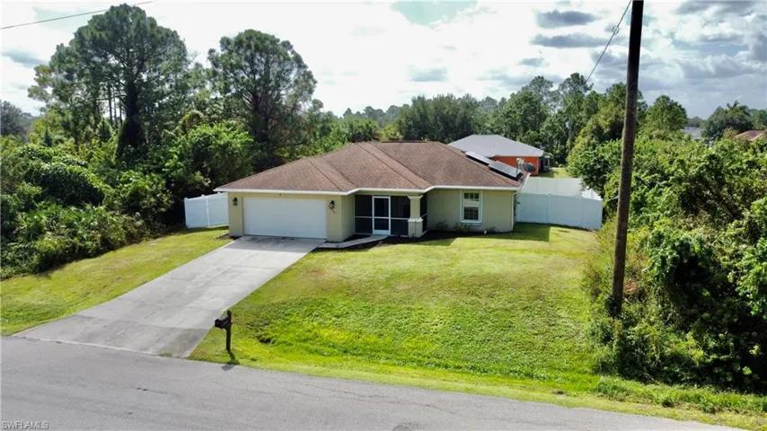 Ranch-style home with a front lawn and a garage