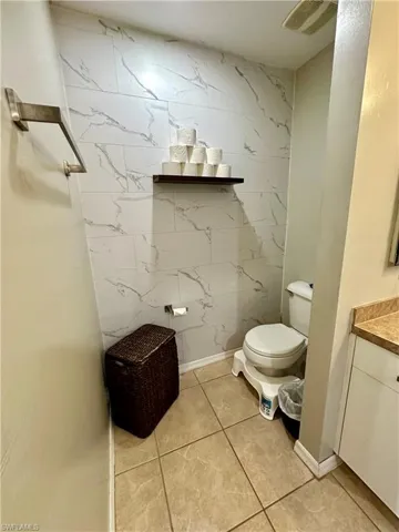 Bathroom featuring tile patterned floors, vanity, and toilet