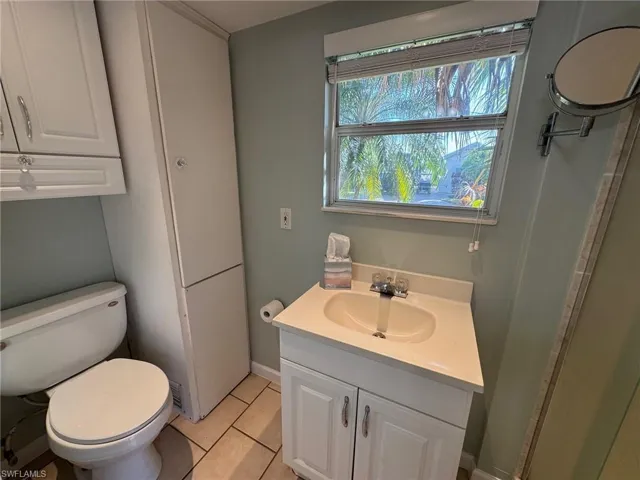 Bathroom featuring tile patterned flooring, vanity, and toilet