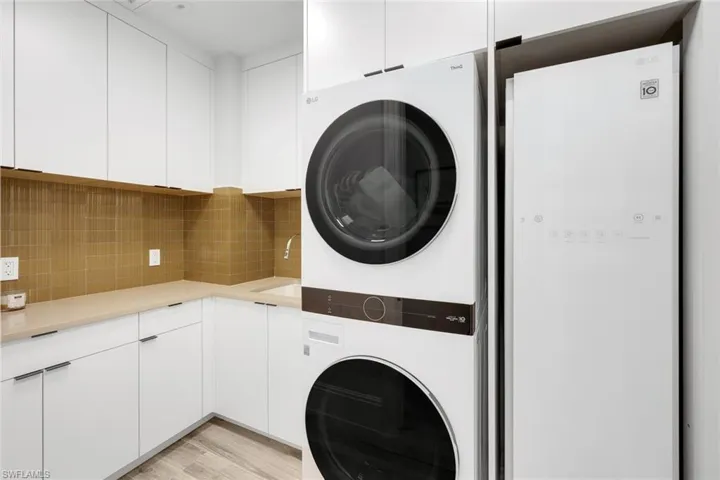 A fully equipped laundry suite features a dedicated steam closet.