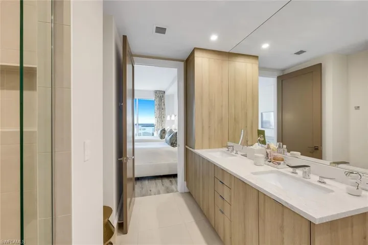 The ensuite bathroom features a large walk-in shower and plenty of storage space.