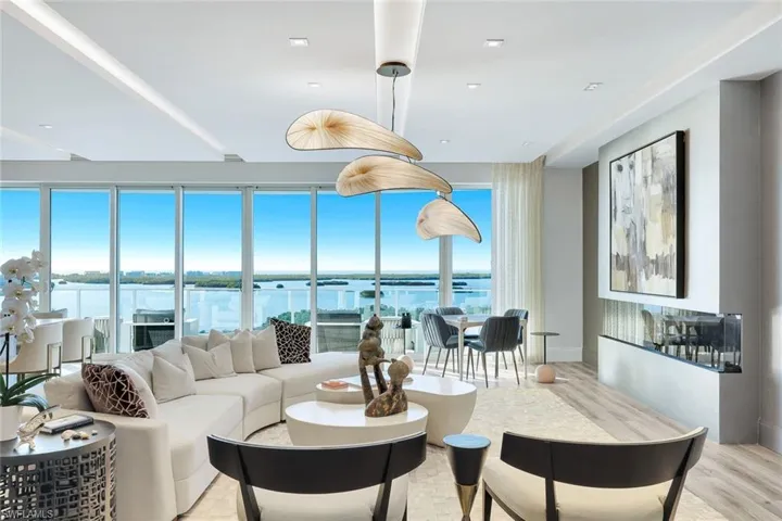 This home's grand open-concept living space offers a seamless blend of sophistication, comfort, and sweeping vistas beyond.