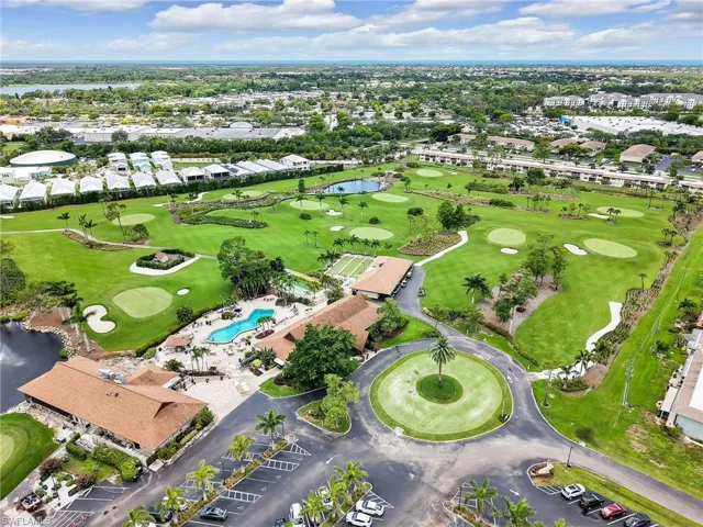 View of property location with a large body of water and a local golf course