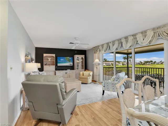 Living area featuring light wood-style flooring and ceiling fan