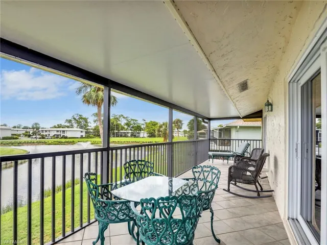 Sunroom with a water view and healthy amount of natural light