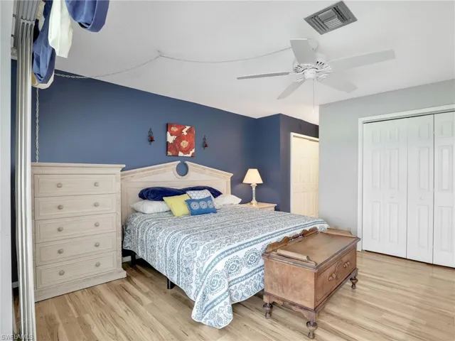 Bedroom with light wood finished floors and a ceiling fan