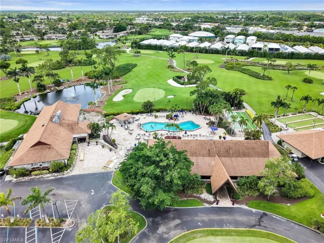 Aerial perspective of suburban area with a local golf course and a large body of water
