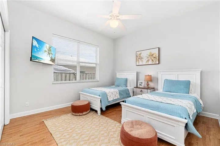 Bedroom with ceiling fan and light hardwood / wood-style floors