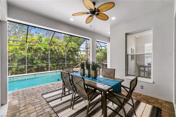 Sunroom featuring ceiling fan