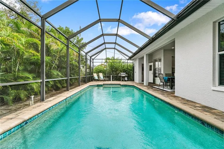View of swimming pool with a patio, a lanai, and area for grilling