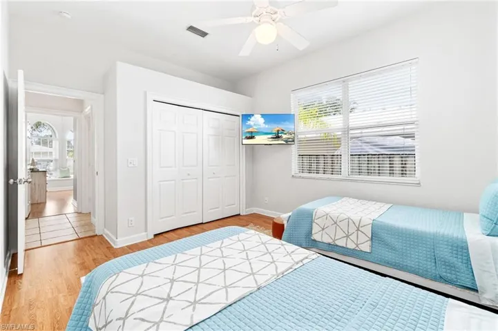 Bedroom featuring a closet, ceiling fan, and light hardwood / wood-style flooring