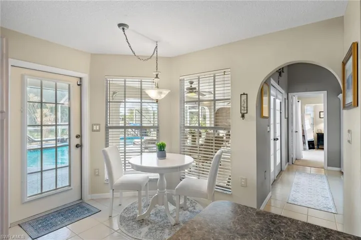 Kitchen Nook featuring ceiling fan, light tile patterned floors, and a textured ceiling