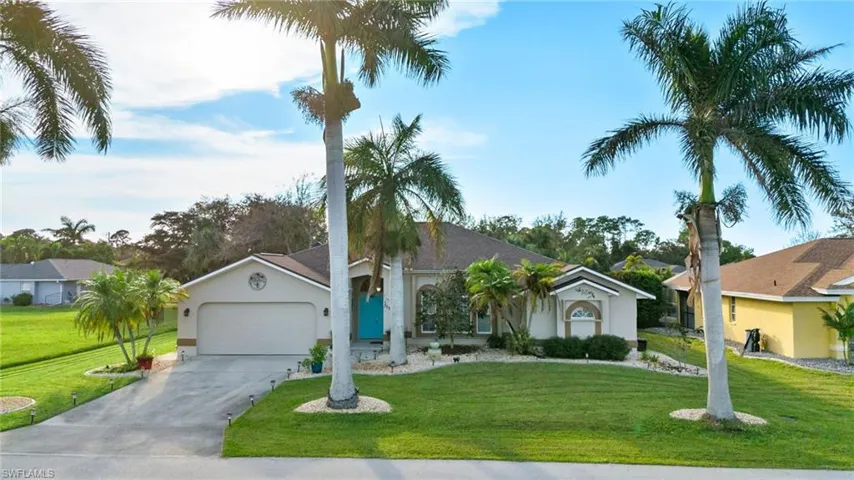 Ranch-style house with a front yard and a garage