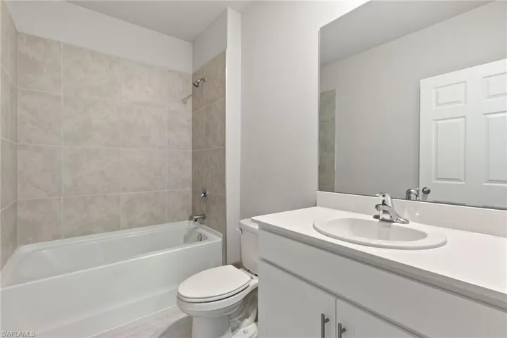 Bathroom featuring bathtub / shower combination and vanity