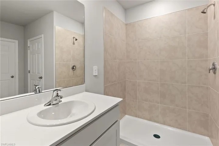 Full bathroom with vanity and a tile shower