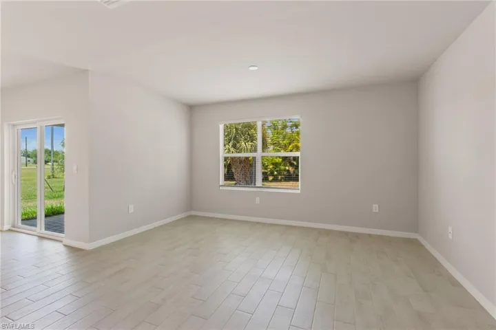 Empty room featuring baseboards and light wood finished floors