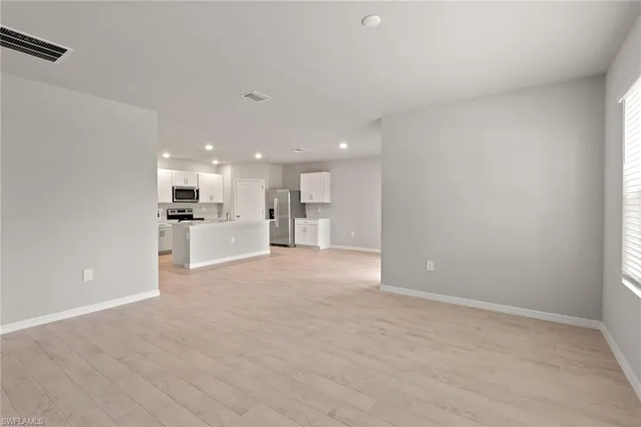 Unfurnished living room with light wood-style flooring and recessed lighting