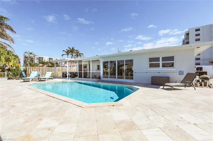 View of swimming pool featuring a patio, fence, and a fenced in pool