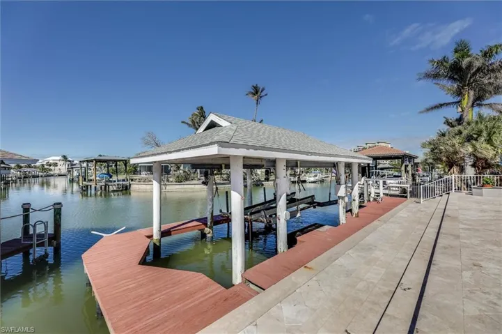View of dock with a water view and boat lift
