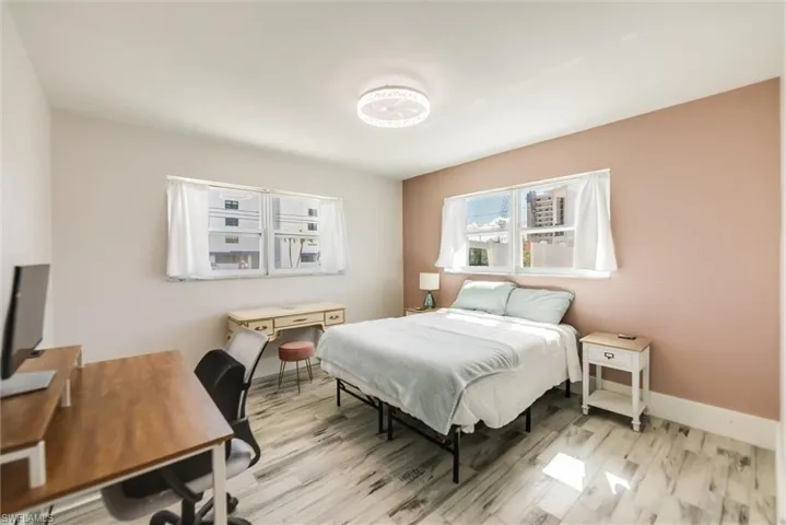 Bedroom with light wood-style floors and baseboards