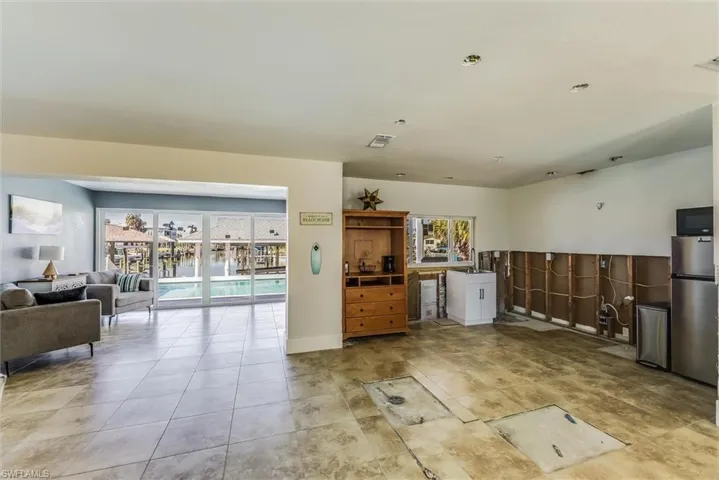 Kitchen featuring a wealth of natural light, freestanding refrigerator, open floor plan, and visible vents