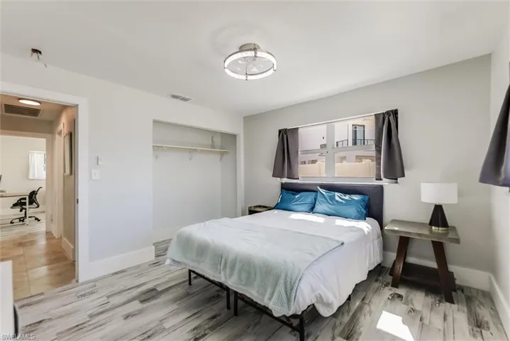 Bedroom with a closet, visible vents, and baseboards