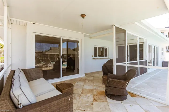 View of patio / terrace featuring area for grilling and a sunroom