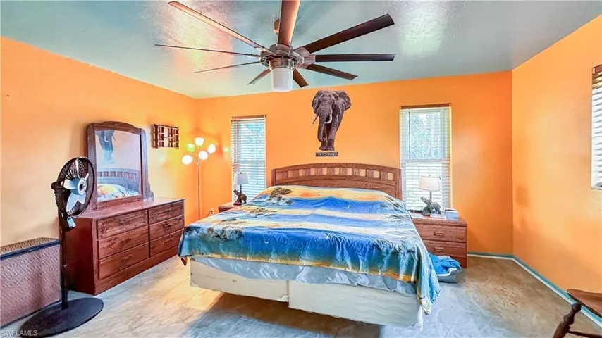 Bedroom featuring multiple windows and ceiling fan