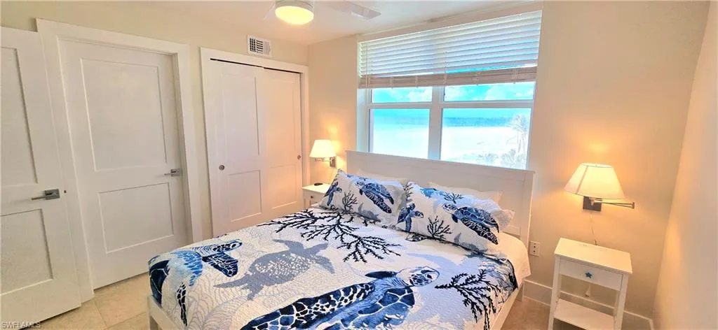 Tiled bedroom featuring a closet and ceiling fan