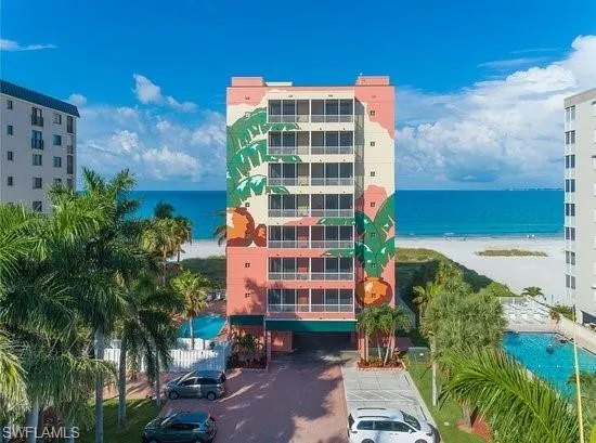View of property with a view of the beach and a water view