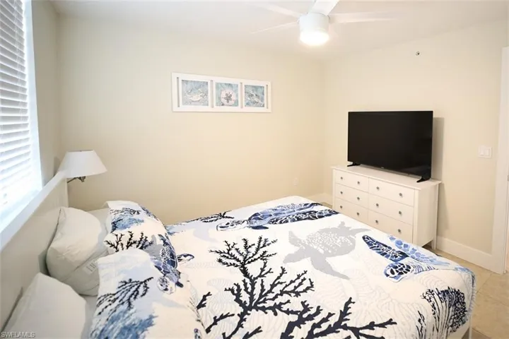 Bedroom featuring tile patterned flooring and ceiling fan