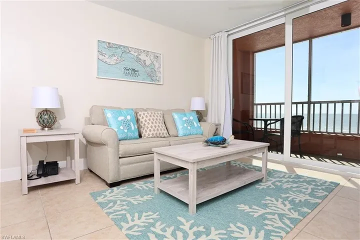 Tiled living room featuring a water view