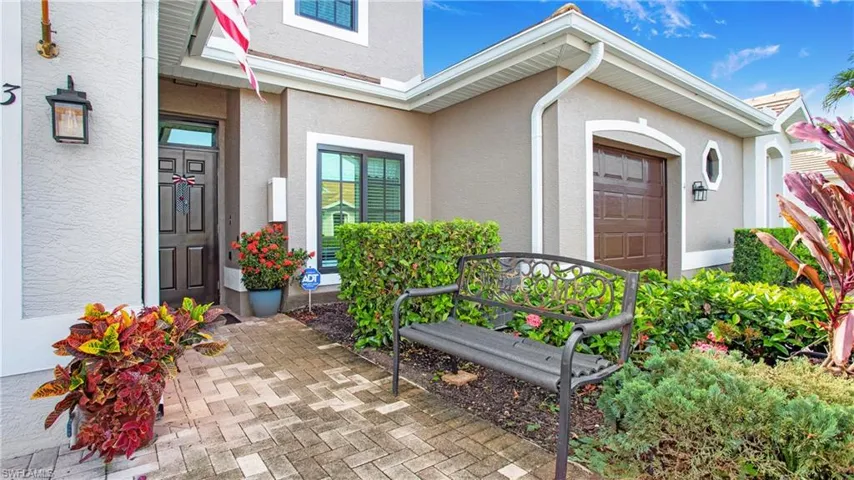 Property entrance featuring stucco siding and a garage