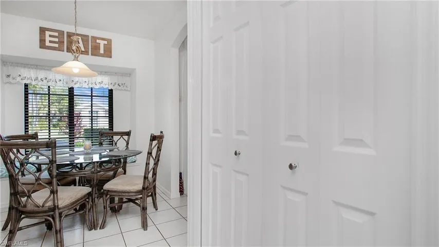 Dining room with light tile patterned floors and arched walkways