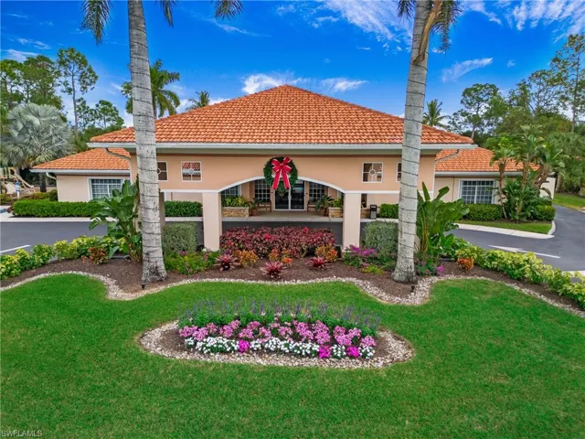 View of side of property with stucco siding, a lawn, and a tile roof