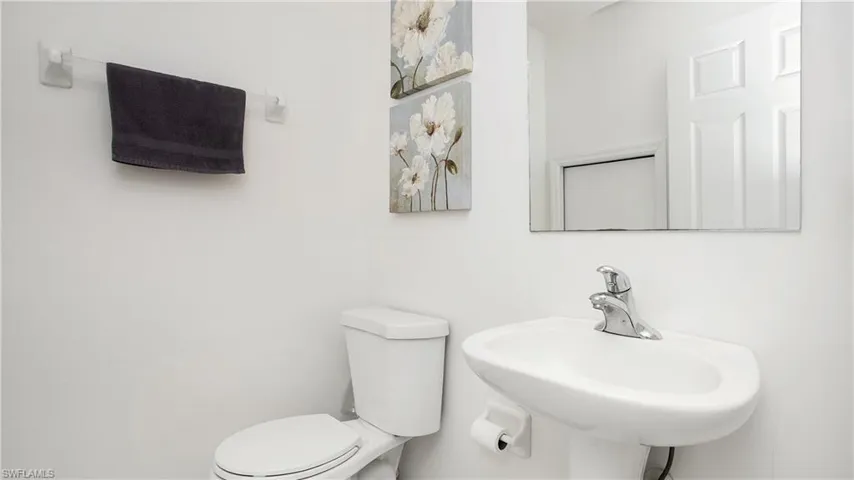 Half bathroom featuring a sink and toilet